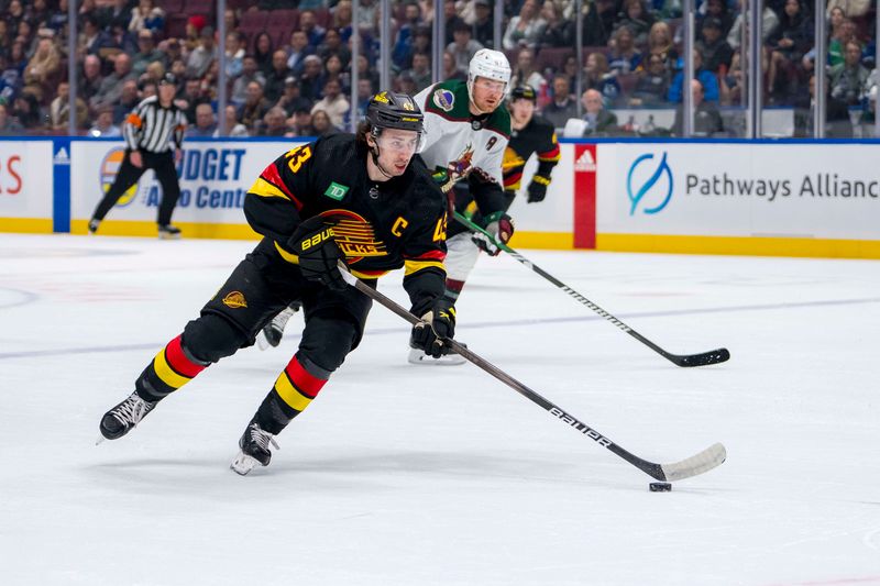 Apr 10, 2024; Vancouver, British Columbia, CAN; Vancouver Canucks defenseman Quinn Hughes (43) handles the puck against the Arizona Coyotes in the first period at Rogers Arena. Mandatory Credit: Bob Frid-USA TODAY Sports