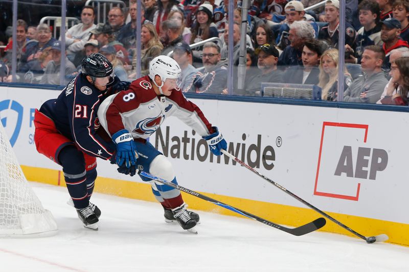 Oct 16, 2025; Columbus, Ohio, USA; Colorado Avalanche defenseman Cale Makar (8) and Columbus Blue Jackets center Isac Lundestrom (21) battle for the puck during the second period at Nationwide Arena. Mandatory Credit: Russell LaBounty-Imagn Images
