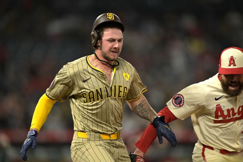 Jun 5, 2024; Anaheim, California, USA;  Los Angeles Angels relief pitcher Matt Moore (55) tags San Diego Padres first baseman Jake Cronenworth (9) out as they run to first base in the ninth inning at Angel Stadium. Mandatory Credit: Jayne Kamin-Oncea-USA TODAY Sports