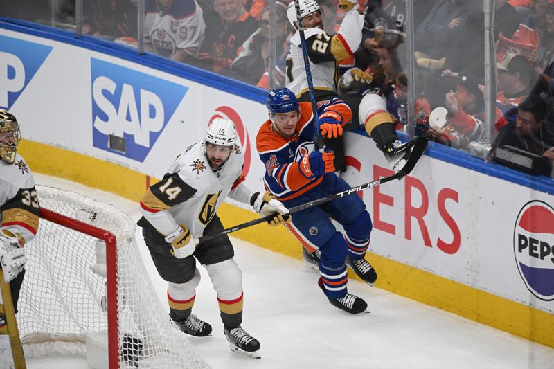 May 12, 2025; Edmonton, Alberta, CAN; Vegas Golden Knights defenseman Nicolas Hague (14) skates against Edmonton Oilers right winger Vasily Podkolzin (92) during the first period in game three of the second round of the 2025 Stanley Cup Playoffs at Rogers Place. Mandatory Credit: Walter Tychnowicz-Imagn Images