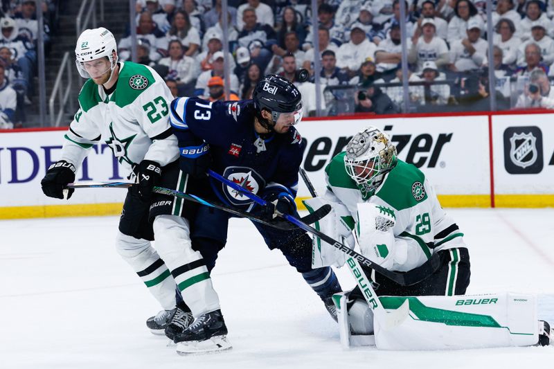 May 15, 2025; Winnipeg, Manitoba, CAN; Dallas Stars goalie Jake Oettinger (29) makes a save as Winnipeg Jets forward Brandon Tanev (73) looks for a rebound during the second period in game five of the second round of the 2025 Stanley Cup Playoffs at Canada Life Centre. Mandatory Credit: Terrence Lee-Imagn Images