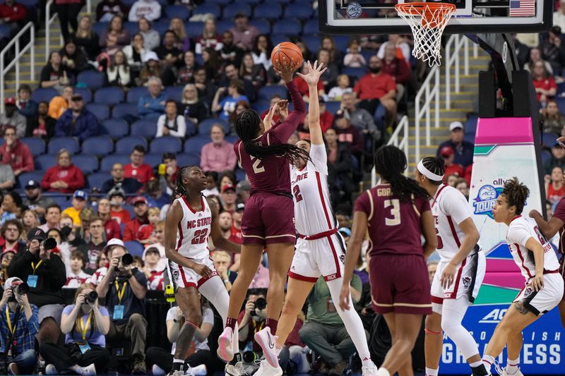 Mar 9, 2024; Greensboro, NC, USA; Florida State Seminoles guard Alexis Tucker (2) shoots the ball over NC State Wolfpack forward Mimi Collins (2) in the first half at Greensboro Coliseum. Mandatory Credit: David Yeazell-USA TODAY Sports