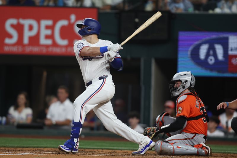 Jul 20, 2024; Arlington, Texas, USA; Texas Rangers catcher Andrew Knizner (12) doubles in two runs against the Baltimore Orioles in the second inning at Globe Life Field. Mandatory Credit: Tim Heitman-USA TODAY Sports