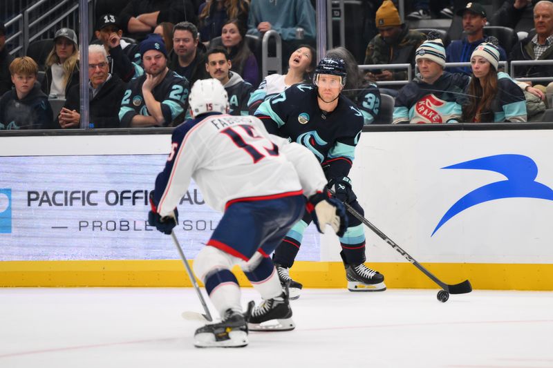 Nov 12, 2024; Seattle, Washington, USA; Seattle Kraken center Jaden Schwartz (17) plays the puck during the third period against the Columbus Blue Jackets at Climate Pledge Arena. Mandatory Credit: Steven Bisig-Imagn Images