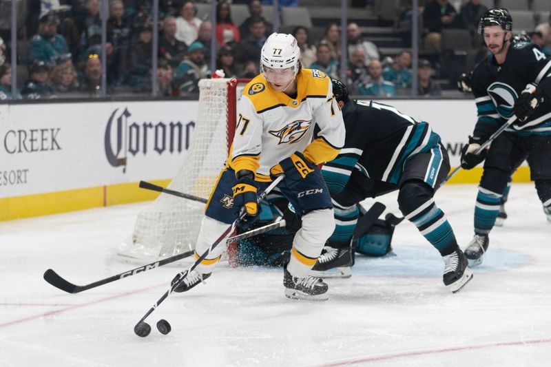 Feb 24, 2024; San Jose, California, USA; Nashville Predators right wing Luke Evangelista (77) keeps the puck away from San Jose Sharks center Luke Kunin (11) during the first period at SAP Center at San Jose. Mandatory Credit: Stan Szeto-USA TODAY Sports