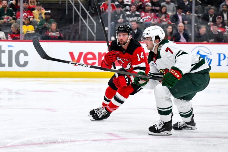 Oct 22, 2025; Newark, New Jersey, USA; New Jersey Devils center Luke Glendening (14) skates against Minnesota Wild defenseman Brock Faber (7) during the second period at Prudential Center. Mandatory Credit: John Jones-Imagn Images