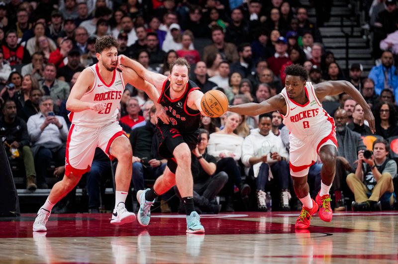 TORONTO, ON - FEBRUARY 9: Alperen Sengun #28 and Jae'Sean Tate #8 of the Houston Rockets battle for a ball against Jakob Poeltl #19 of the Toronto Raptors during the second half of their basketball game at the Scotiabank Arena on February 9, 2024 in Toronto, Ontario, Canada. NOTE TO USER: User expressly acknowledges and agrees that, by downloading and/or using this Photograph, user is consenting to the terms and conditions of the Getty Images License Agreement. (Photo by Mark Blinch/Getty Images)