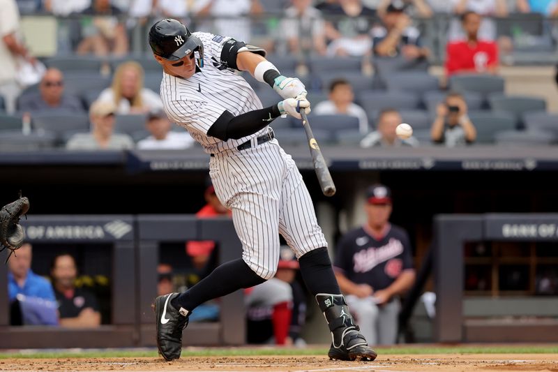 Aug 24, 2023; Bronx, New York, USA; New York Yankees right fielder Aaron Judge (99) hits a solo home run against the Washington Nationals during the first inning at Yankee Stadium. Mandatory Credit: Brad Penner-USA TODAY Sports