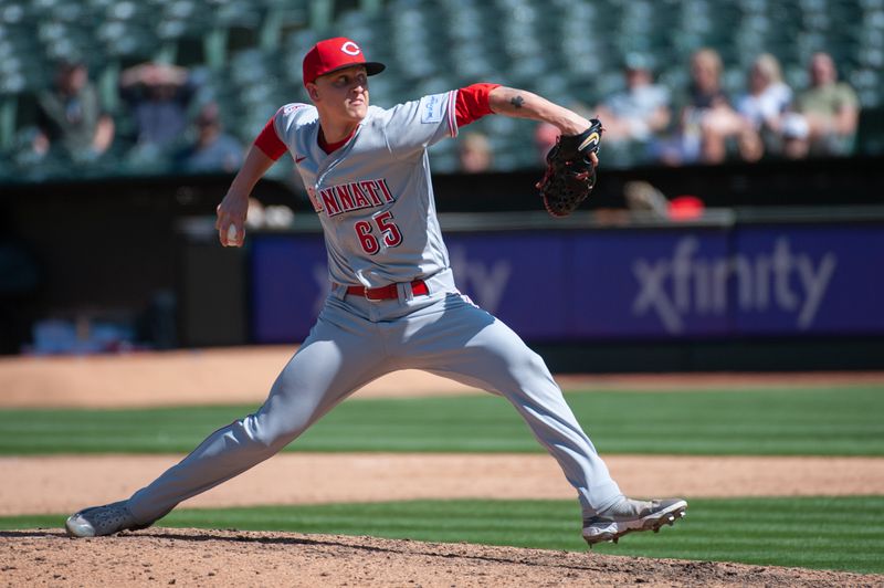 Apr 29, 2023; Oakland, California, USA; Cincinnati Reds relief pitcher Casey Legumina (65) throws a pitch during the eighth inning against the Oakland Athletics at RingCentral Coliseum. Mandatory Credit: Ed Szczepanski-USA TODAY Sports