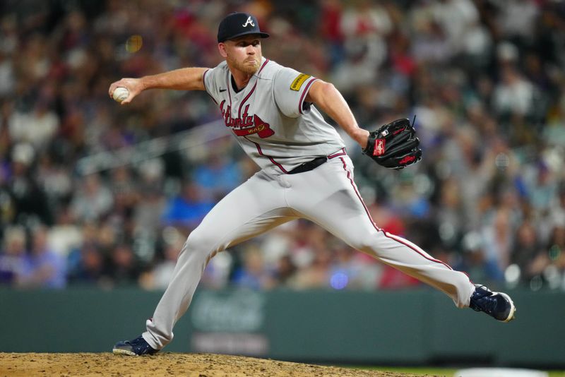 Aug 30, 2023; Denver, Colorado, USA; Atlanta Braves relief pitcher Michael Tonkin (51) delivers a pitch in the seventh inning against the Colorado Rockies at Coors Field. Mandatory Credit: Ron Chenoy-USA TODAY Sports