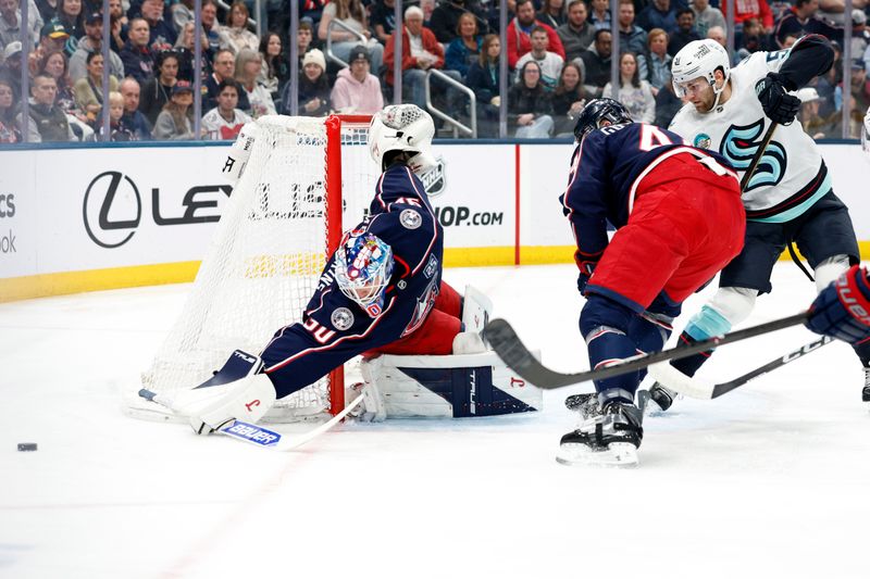 Mar 21, 2026; Columbus, Ohio, USA; Columbus Blue Jackets goalie Elvis Merzlikins (90) makes a stick save against the Seattle Kraken during the first period at Nationwide Arena. Mandatory Credit: Russell LaBounty-Imagn Images