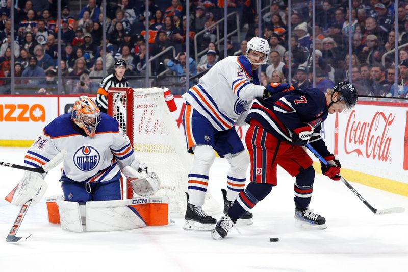 Mar 26, 2024; Winnipeg, Manitoba, CAN; Edmonton Oilers defenseman Darnell Nurse (25) and Winnipeg Jets center Vladislav Namestnikov (7) fight for the puck beside Edmonton Oilers goaltender Stuart Skinner (74) in the second period at Canada Life Centre. Mandatory Credit: James Carey Lauder-USA TODAY Sports