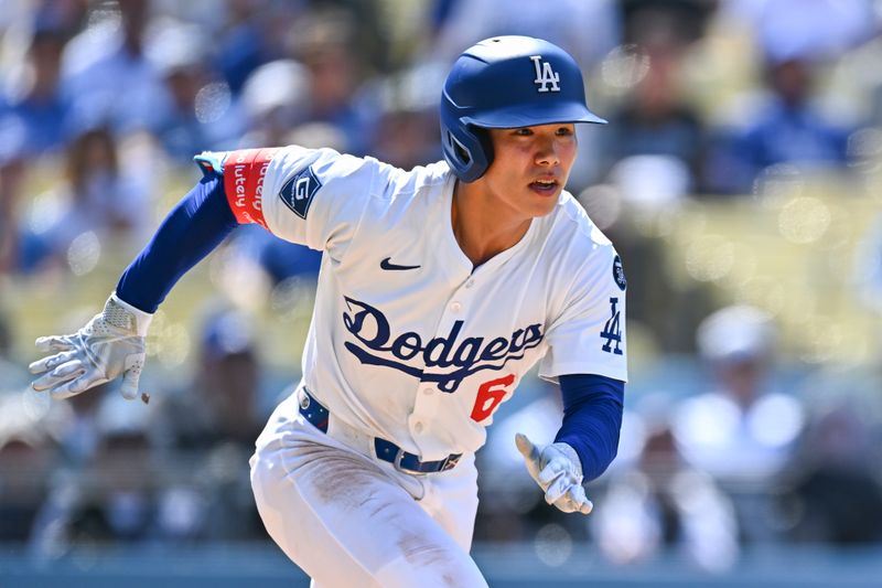 Jul 20, 2025; Los Angeles, California, USA; Los Angeles Dodgers pinch hitter Hyeseong Kim (6) runs to first base against the Milwaukee Brewers during the ninth inning at Dodger Stadium. Mandatory Credit: Jonathan Hui-Imagn Images
