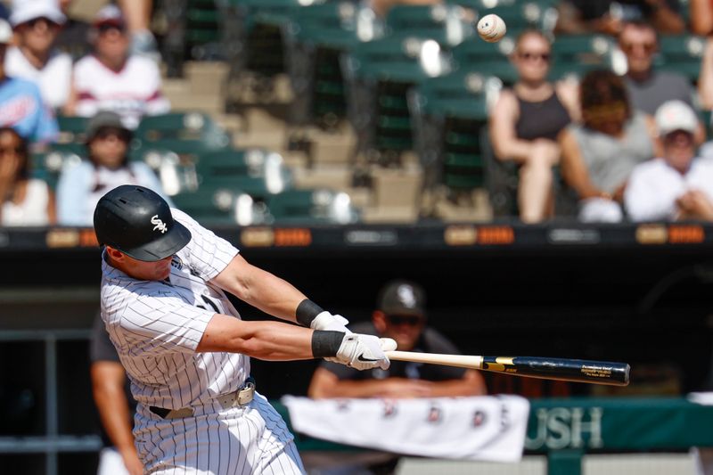 Sep 15, 2024; Chicago, Illinois, USA; Chicago White Sox first baseman Andrew Vaughn (21) hits an RBI-single against the Oakland Athletics during the first inning at Guaranteed Rate Field. Mandatory Credit: Kamil Krzaczynski-Imagn Images