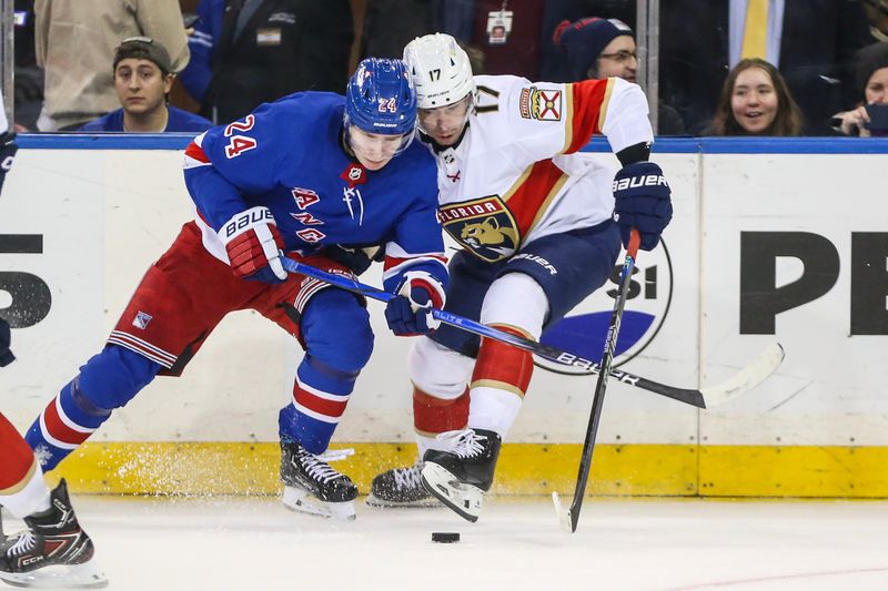 Mar 4, 2024; New York, New York, USA;  New York Rangers right wing Kaapo Kakko (24) and Florida Panthers center Evan Rodrigues (17) battle for control of the puck in the third period at Madison Square Garden. Mandatory Credit: Wendell Cruz-USA TODAY Sports