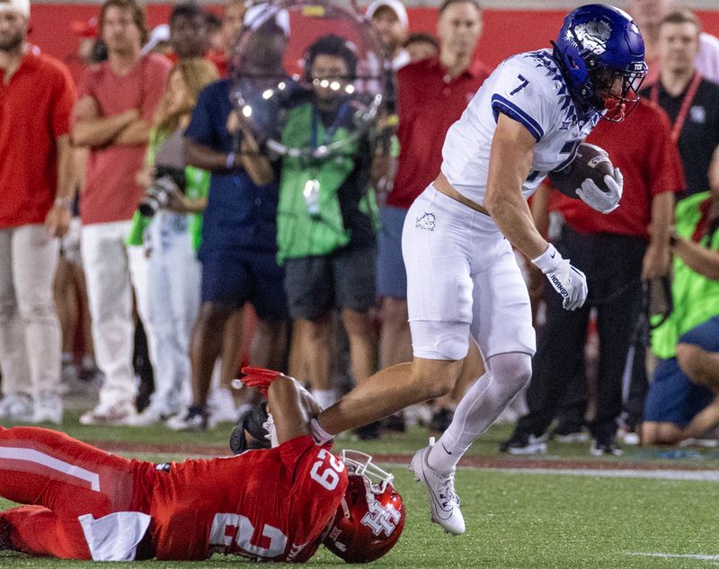 Sep 16, 2023; Houston, Texas, USA;TCU Horned Frogs wide receiver JP Richardson (7) breaks a tackle by Houston Cougars linebacker Treylin Payne (29) in the first half at TDECU Stadium. Mandatory Credit: Thomas Shea-USA TODAY Sports