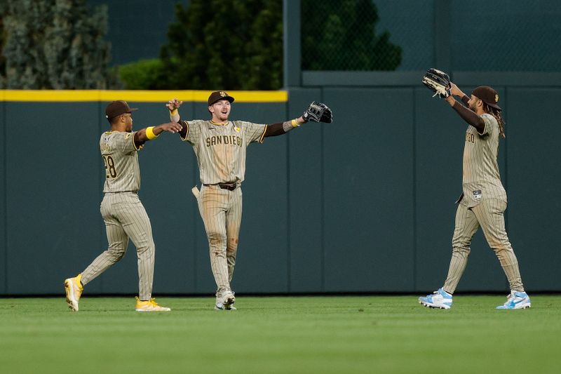 Apr 24, 2024; Denver, Colorado, USA; San Diego Padres left fielder Jose Azocar (28) and center fielder Jackson Merrill (3) and right fielder Fernando Tatis Jr. (23) react after the game against the Colorado Rockies at Coors Field. Mandatory Credit: Isaiah J. Downing-USA TODAY Sports