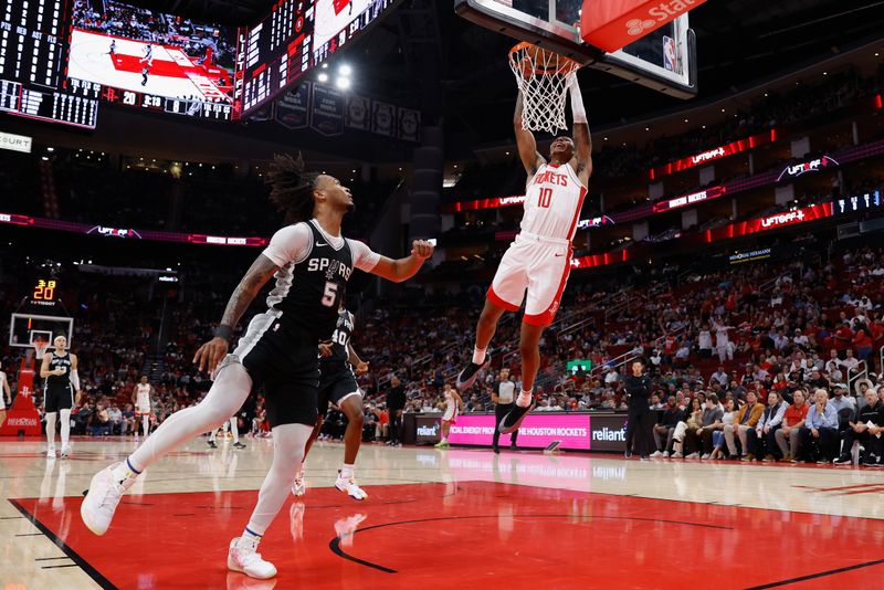 HOUSTON, TEXAS - NOVEMBER 06: Jabari Smith Jr. #10 of the Houston Rockets dunks the ball in front of Stephon Castle #5 of the San Antonio Spurs in the first half at Toyota Center on November 06, 2024 in Houston, Texas.  NOTE TO USER: User expressly acknowledges and agrees that, by downloading and or using this photograph, User is consenting to the terms and conditions of the Getty Images License Agreement.  (Photo by Tim Warner/Getty Images)