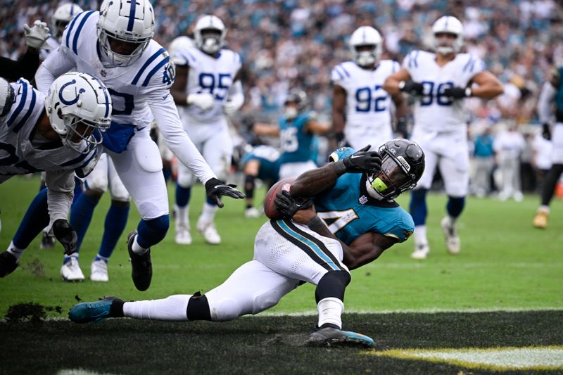 Jacksonville Jaguars running back Tank Bigsby (4) goes in for a touchdown during the second half of an NFL football game against the Indianapolis Colts, Sunday, Oct. 6, 2024, in Jacksonville, Fla. (AP Photo/Phelan M. Ebenhack)