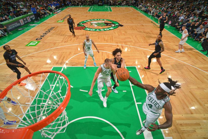 BOSTON, MA - JUNE 6: Jrue Holiday #4 of the Boston Celtics rebounds the ball during the game against the Dallas Mavericks during Game 1 of the 2024 NBA Finals on June 6, 2024 at the TD Garden in Boston, Massachusetts. NOTE TO USER: User expressly acknowledges and agrees that, by downloading and or using this photograph, User is consenting to the terms and conditions of the Getty Images License Agreement. Mandatory Copyright Notice: Copyright 2024 NBAE  (Photo by Jesse D. Garrabrant/NBAE via Getty Images)