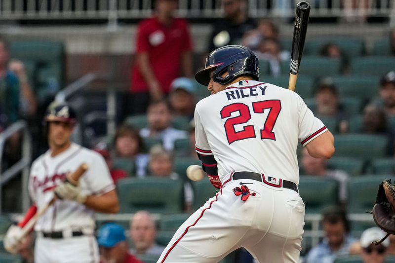 Sep 6, 2023; Cumberland, Georgia, USA; Atlanta Braves third baseman Austin Riley (27) is hit by a pitch against the St. Louis Cardinals during the first inning at Truist Park. Mandatory Credit: Dale Zanine-USA TODAY Sports