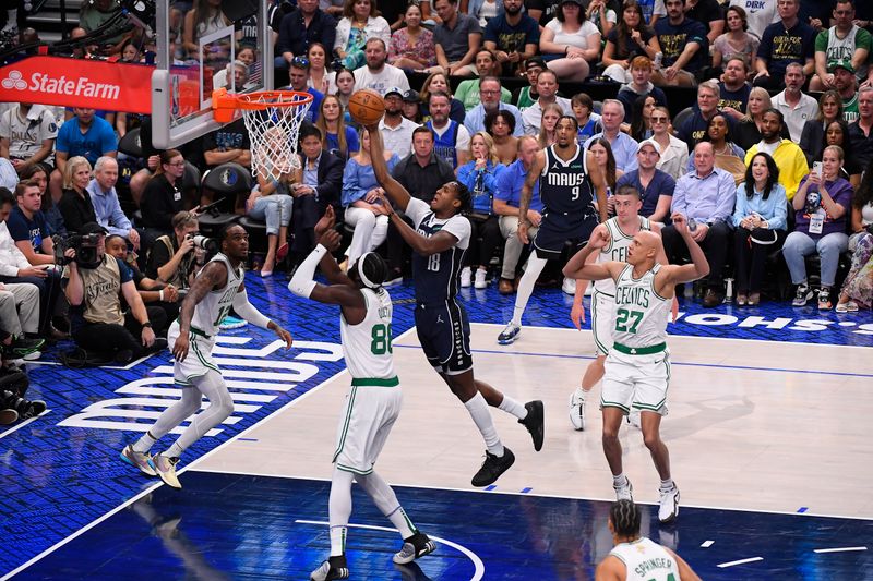 DALLAS, TX - JUNE 14: Olivier Maxence-Prosper #18 of the Dallas Mavericks drives to the basket during the game against the Boston Celtics during Game 4 of the 2024 NBA Finals on June 14, 2024 at the American Airlines Center in Dallas, Texas. NOTE TO USER: User expressly acknowledges and agrees that, by downloading and or using this photograph, User is consenting to the terms and conditions of the Getty Images License Agreement. Mandatory Copyright Notice: Copyright 2024 NBAE (Photo by Brian Babineau/NBAE via Getty Images)