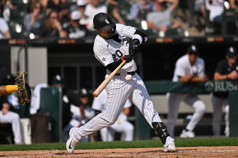Sep 21, 2025; Chicago, Illinois, USA; Chicago White Sox third baseman Miguel Vargas (20) hits a single against the San Diego Padres during the sixth inning at Rate Field. Mandatory Credit: Patrick Gorski-Imagn Images