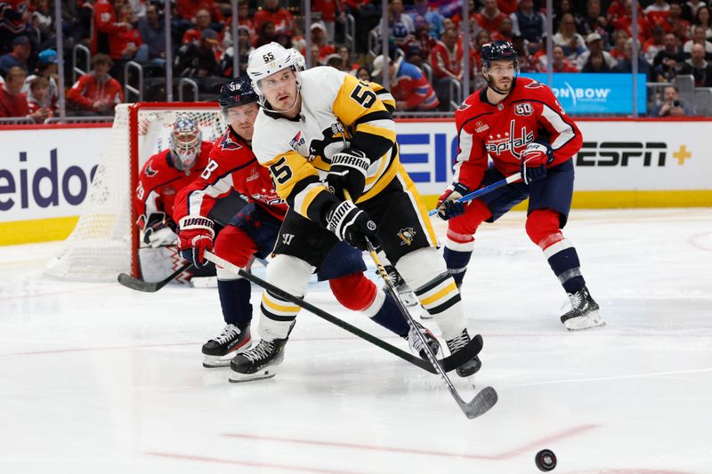 Nov 8, 2024; Washington, District of Columbia, USA; Pittsburgh Penguins center Noel Acciari (55) passes the puck as Washington Capitals defenseman Rasmus Sandin (38) defen ds in the second period at Capital One Arena. Mandatory Credit: Geoff Burke-Imagn Images