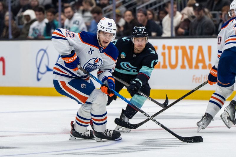 Oct 25, 2025; Seattle, Washington, USA; Edmonton Oilers forward Vasily Podkolzin (92) skates against Seattle Kraken forward Jaden Schwartz (17) during the second period at Climate Pledge Arena. Mandatory Credit: Stephen Brashear-Imagn Images