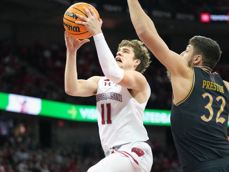 Jan 13, 2024; Madison, Wisconsin, USA; Wisconsin Badgers guard Max Klesmit (11) attempts a shot while defended by Northwestern Wildcats forward Blake Preston (32) during the second half at the Kohl Center. Mandatory Credit: Kayla Wolf-USA TODAY Sports