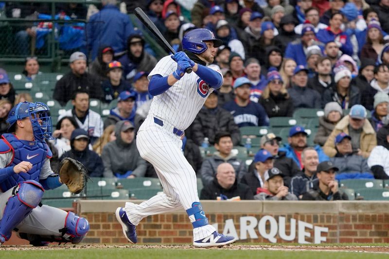 Apr 7, 2024; Chicago, Illinois, USA; Chicago Cubs first baseman Michael Busch (29) hits a three-run double against the Los Angeles Dodgers during the first inning at Wrigley Field. Mandatory Credit: David Banks-USA TODAY Sports