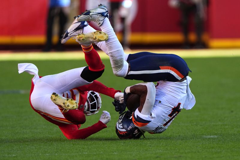 Denver Broncos wide receiver Courtland Sutton, right, is stopped by Kansas City Chiefs defensive back Chamarri Conner during the second half of an NFL football game Sunday, Nov. 10, 2024, in Kansas City, Mo. (AP Photo/Charlie Riedel)