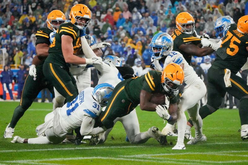 Green Bay Packers running back Emanuel Wilson lunges into the end zone for a touchdown during the second half of an NFL football game against the Detroit Lions, Sunday, Nov. 3, 2024, in Green Bay, Wis. (AP Photo/Morry Gash)