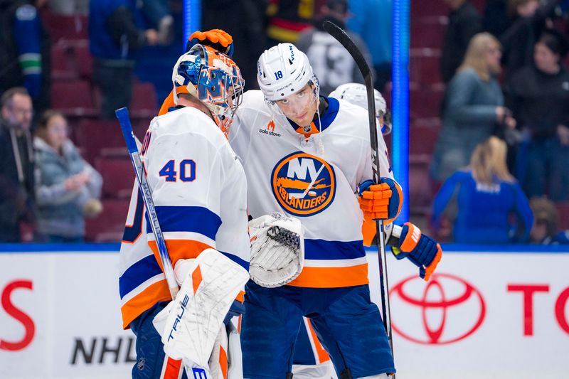 Nov 14, 2024; Vancouver, British Columbia, CAN; New York Islanders goalie Semyon Varlamov (40) and forward Pierre Engvall (18) celebrate their victroy against the Vancouver Canucks at Rogers Arena. Mandatory Credit: Bob Frid-Imagn Images