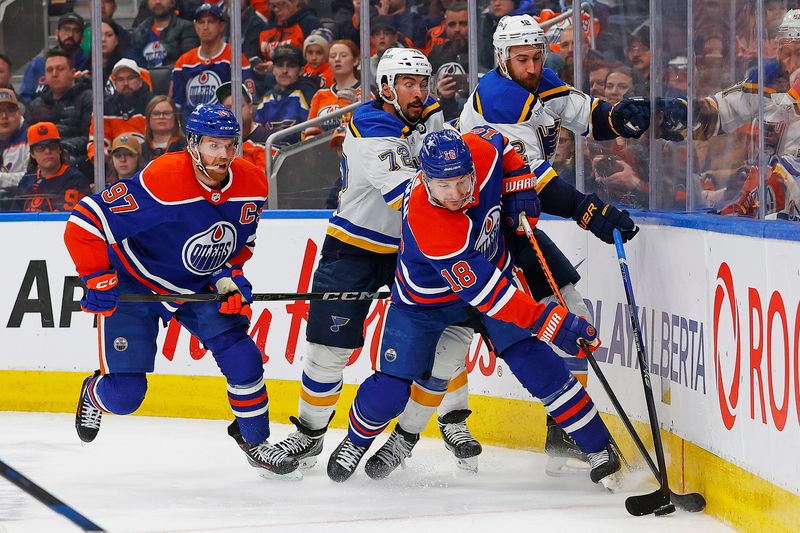 Feb 28, 2024; Edmonton, Alberta, CAN; Edmonton Oilers forward Zach Hyman (18) and St. Louis Blues forward Kevin Hayes (12) Battle along the boards for a loose puck during the third period at Rogers Place. Mandatory Credit: Perry Nelson-USA TODAY Sports