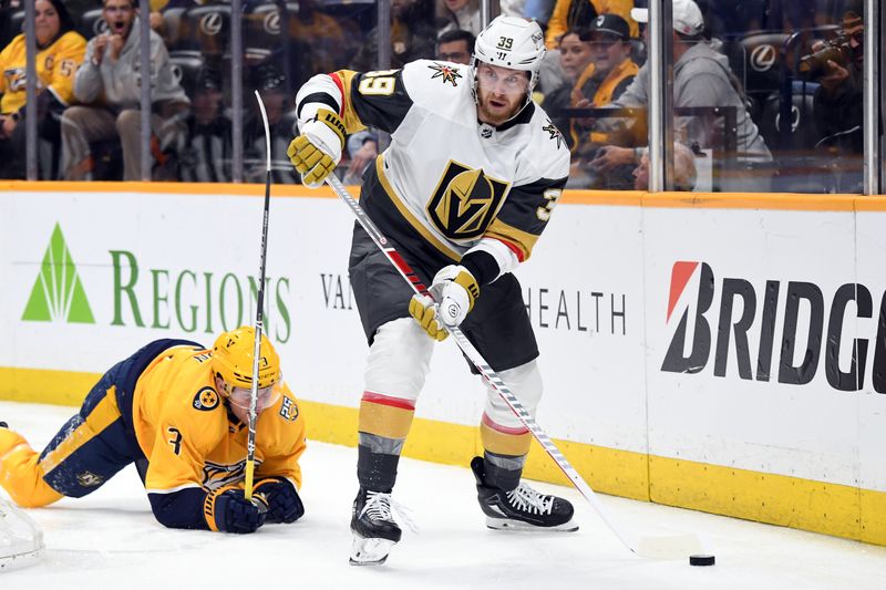 Mar 26, 2024; Nashville, Tennessee, USA; Vegas Golden Knights right wing Anthony Mantha (39) looks to pass the puck after a hit against Nashville Predators defenseman Jeremy Lauzon (3) during the second period at Bridgestone Arena. Mandatory Credit: Christopher Hanewinckel-USA TODAY Sports