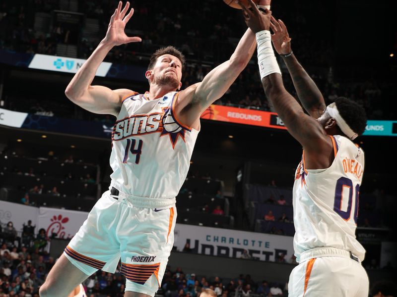CHARLOTTE, NC - MARCH 15: Drew Eubanks #14 of the Phoenix Suns rebounds the ball during the game against the Charlotte Hornets on March 15, 2024 at Spectrum Center in Charlotte, North Carolina. NOTE TO USER: User expressly acknowledges and agrees that, by downloading and or using this photograph, User is consenting to the terms and conditions of the Getty Images License Agreement. Mandatory Copyright Notice: Copyright 2024 NBAE (Photo by Kent Smith/NBAE via Getty Images)