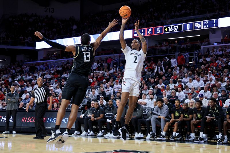 Feb 4, 2023; Cincinnati, Ohio, USA;  Cincinnati Bearcats guard Landers Nolley II (2) takes a shot against UCF Knights guard C.J. Kelly (13) in the first half at Fifth Third Arena. Mandatory Credit: Aaron Doster-USA TODAY Sports