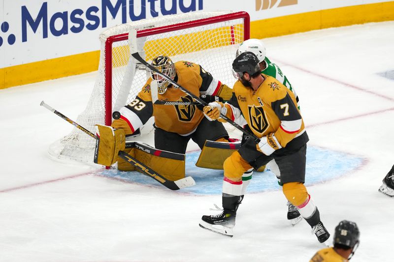 May 3, 2024; Las Vegas, Nevada, USA; Vegas Golden Knights goaltender Adin Hill (33) makes a blocker save as Dallas Stars center Roope Hintz (24) looks for a rebound during the third period of game six of the first round of the 2024 Stanley Cup Playoffs at T-Mobile Arena. Mandatory Credit: Stephen R. Sylvanie-USA TODAY Sports