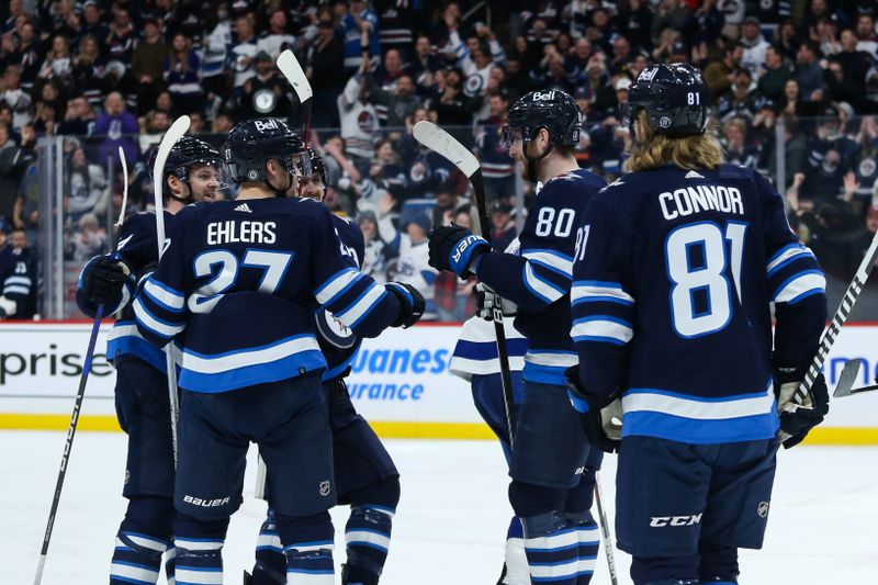 Jan 6, 2023; Winnipeg, Manitoba, CAN;  Winnipeg Jets forward Pierre-Luc Dubois (80) is congratulated by his team mates on his goal against the Tampa Bay Lightning during the second period at Canada Life Centre. Mandatory Credit: Terrence Lee-USA TODAY Sports