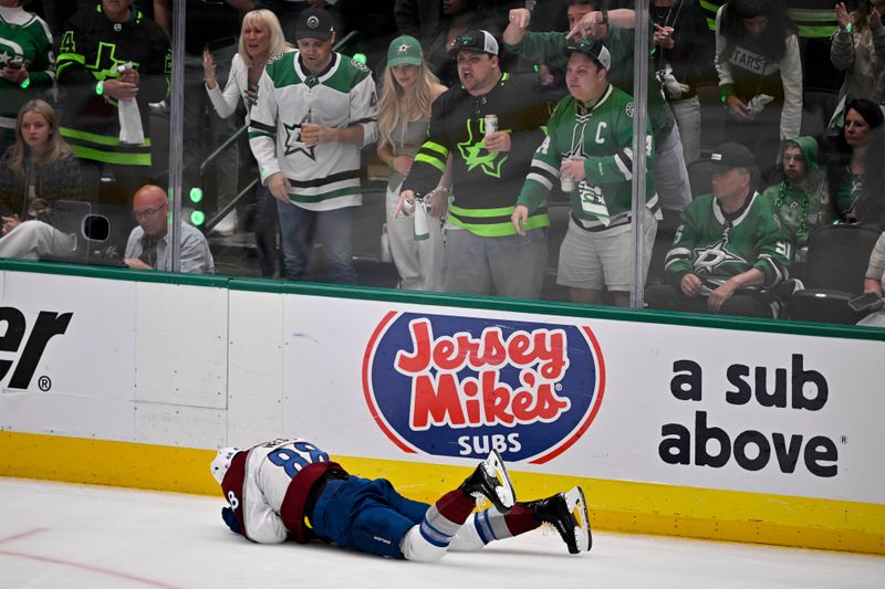 May 3, 2025; Dallas, Texas, USA; Colorado Avalanche center Martin Necas (88) falls to the ice in front of the Dallas Stars fans during the third period in game seven of the first round of the 2025 Stanley Cup Playoffs at American Airlines Center. Mandatory Credit: Jerome Miron-Imagn Images