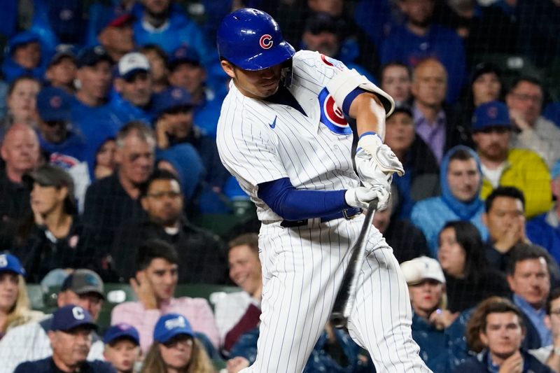 Sep 19, 2023; Chicago, Illinois, USA; Chicago Cubs right fielder Seiya Suzuki (27) hit a single against the Pittsburgh Pirates during the fifth inning at Wrigley Field. Mandatory Credit: David Banks-USA TODAY Sports