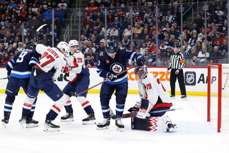 Mar 11, 2024; Winnipeg, Manitoba, CAN; Winnipeg Jets left wing Alex Iafallo (9) tips in the puck past Washington Capitals goaltender Charlie Lindgren (79) for his goal in the second period at Canada Life Centre. Mandatory Credit: James Carey Lauder-USA TODAY Sports