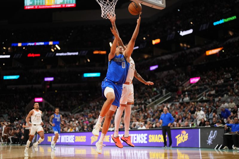 SAN ANTONIO, TX - MARCH 19: Dante Exum #0 of the Dallas Mavericks drives to the basket during the game against the San Antonio Spurs on March 19, 2024 at the Frost Bank Center in San Antonio, Texas. NOTE TO USER: User expressly acknowledges and agrees that, by downloading and or using this photograph, user is consenting to the terms and conditions of the Getty Images License Agreement. Mandatory Copyright Notice: Copyright 2024 NBAE (Photos by Darren Carroll/NBAE via Getty Images)