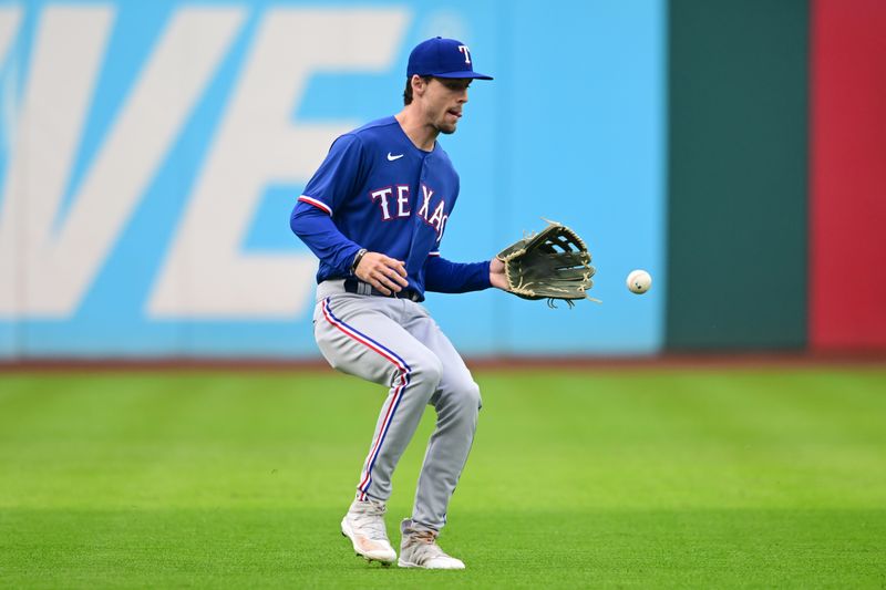 Sep 16, 2023; Cleveland, Ohio, USA; Texas Rangers left fielder Evan Carter (32) fields a ball hit by Cleveland Guardians first baseman Josh Naylor (not pictured) during the first inning at Progressive Field. Mandatory Credit: Ken Blaze-USA TODAY Sports