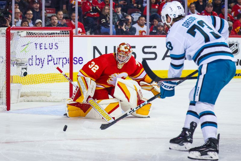 Apr 12, 2023; Calgary, Alberta, CAN; San Jose Sharks center Noah Gregor (73) scores a goal against Calgary Flames goaltender Dustin Wolf (32) during the first period at Scotiabank Saddledome. Mandatory Credit: Sergei Belski-USA TODAY Sports