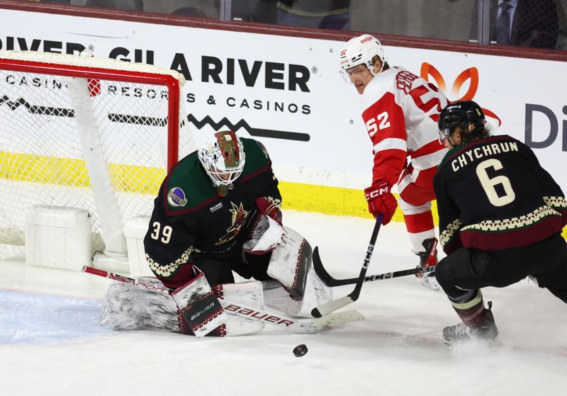 Jan 17, 2023; Tempe, Arizona, USA; Arizona Coyotes goalie Connor Ingram (39) blocks a shot by Detroit Red Wings right wing Jonatan Berggren (52) in the second period at Mullett Arena. Mandatory Credit: Mark J. Rebilas-USA TODAY Sports
