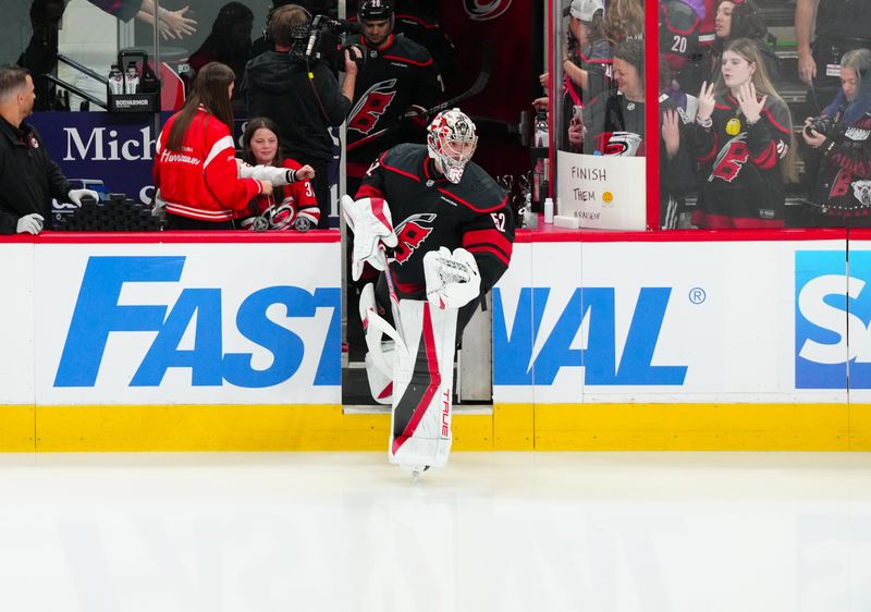 Apr 29, 2025; Raleigh, North Carolina, USA; Carolina Hurricanes goaltender Pyotr Kochetkov (52) skates out onto the ice from the warmups before the game against the New Jersey Devils in game five of the first round of the 2025 Stanley Cup Playoffs at Lenovo Center. Mandatory Credit: James Guillory-Imagn Images