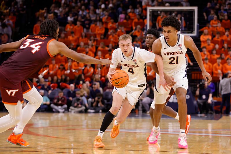 Feb 1, 2025; Charlottesville, Virginia, USA; Virginia Cavaliers guard Andrew Rohde (4) controls the ball as Virginia Tech Hokies forward Mylyjael Poteat (34) defends during the second half at John Paul Jones Arena. Mandatory Credit: Amber Searls-Imagn Images