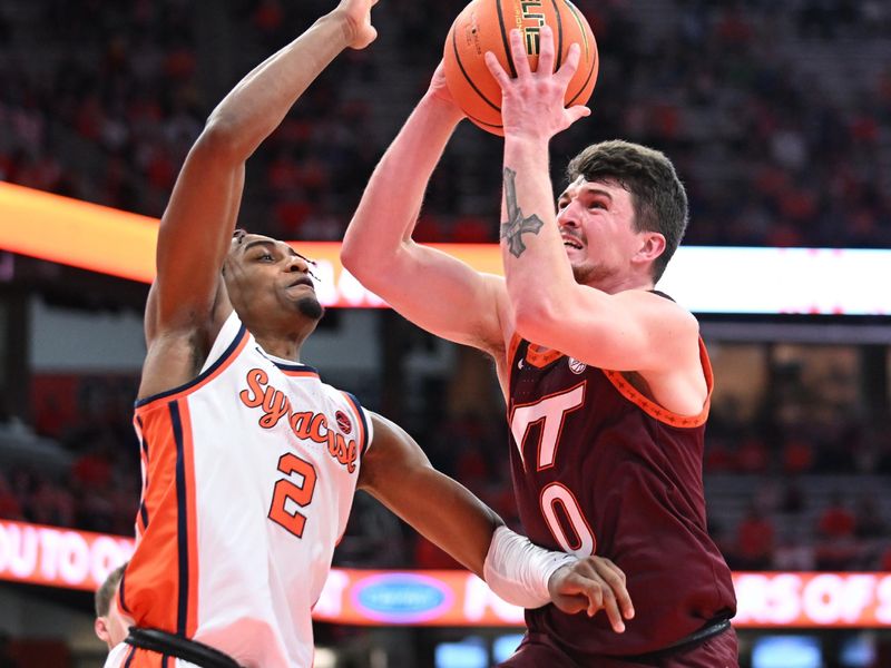 Feb 27, 2024; Syracuse, New York, USA; Virginia Tech Hokies guard Hunter Cattoor (0) takes a shot with Syracuse Orange guard JJ Starling (2) defending in the first half at the JMA Wireless Dome. Mandatory Credit: Mark Konezny-USA TODAY Sports